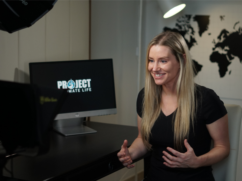 Professional woman reviewing speaker materials on screen